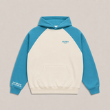 Cremefarbener Hej Nika Hoodie mit türkiser Kapuze, Raglanärmeln, Kängurutasche, Brustlogo und weißem Ärmelprint