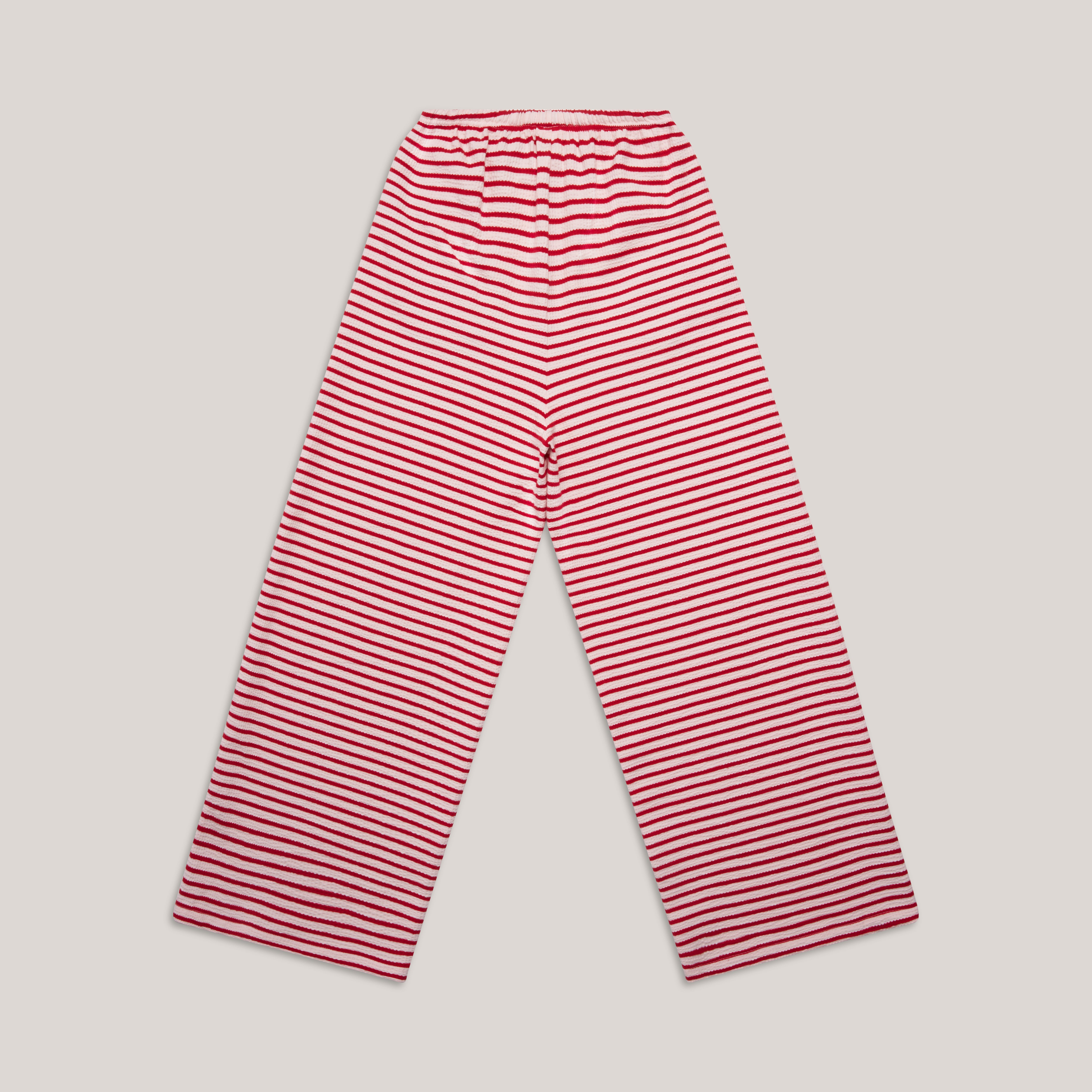 Rückansicht der locker geschnittenen Hose mit Streifenmuster in Rosa und Rot, elastischem Bund und weitem Bein aus Bio-Baumwolle.